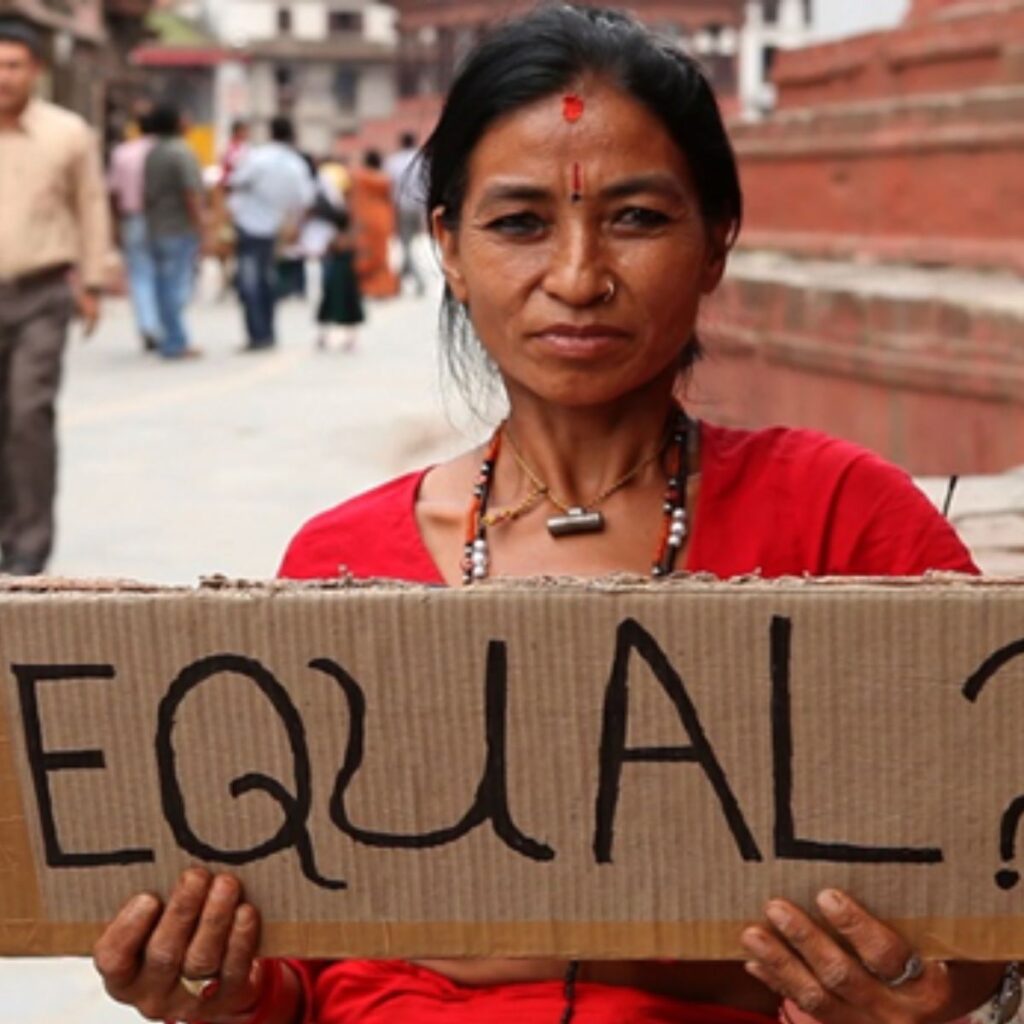 A woman holds up a sign saying equal