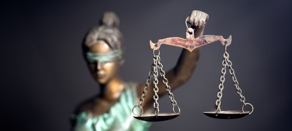 Justice scales being held aloft